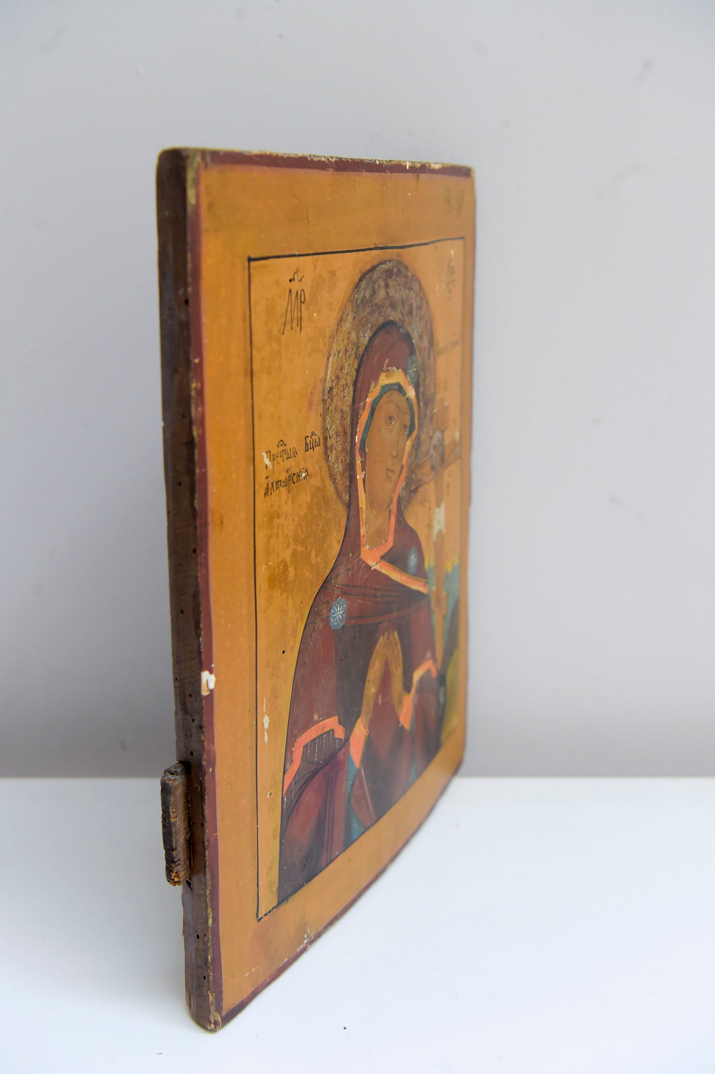 19TH CENTURY Antique Russian Icon on a Curved Wooden Panel. Mother of God and the crucifixion of christ The Wood panel has two reinforcement slats and text to the back.