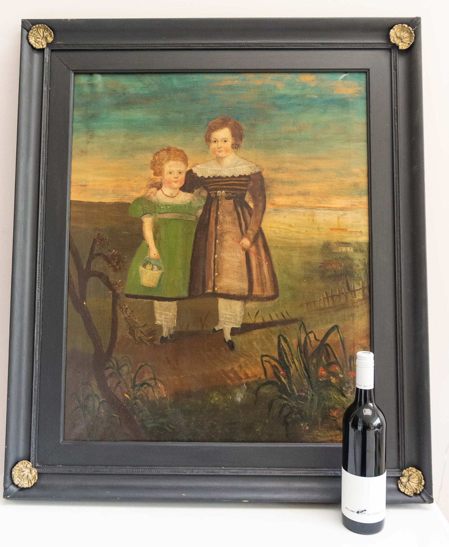 Large 19th century naive oil on canvas of two children standing in a landscape.