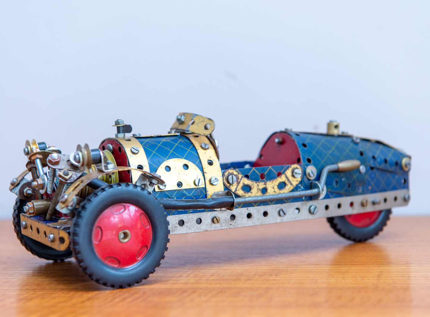 A Fine Scratch Built Meccano 3 Wheel Racing Car In Red Blue And Gold. Made In England. Circa 1940